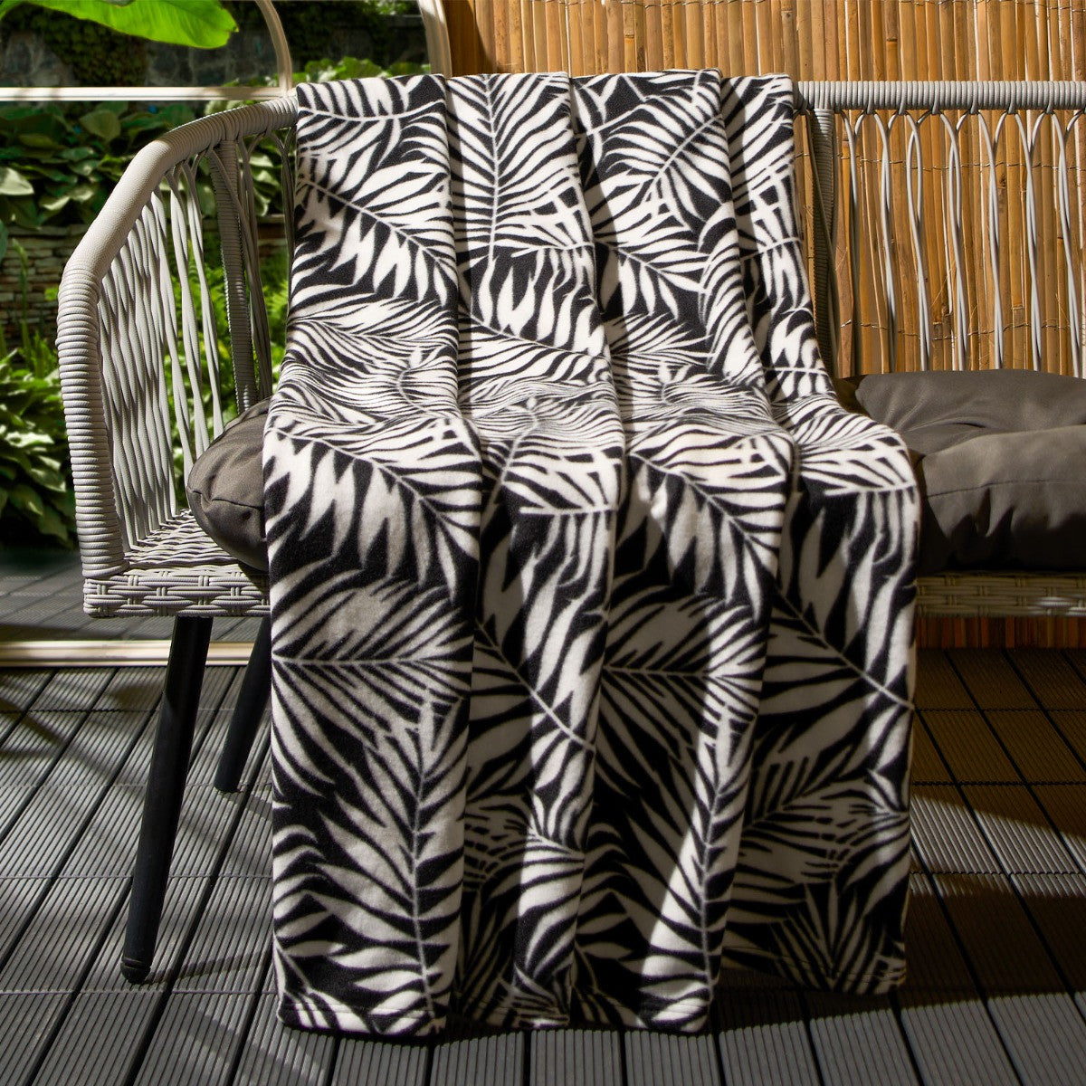 leaf print fleece throw blanket styled on sofa showing soft texture and decorative pattern