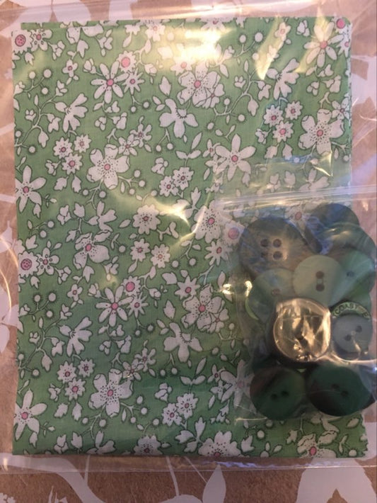 sunny fat quarter with buttons showcasing green fabric with white flowers and mixed media button selection
