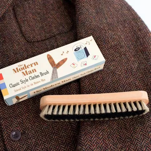 classic wooden clothes brush with synthetic bristles presented in modern man gift box