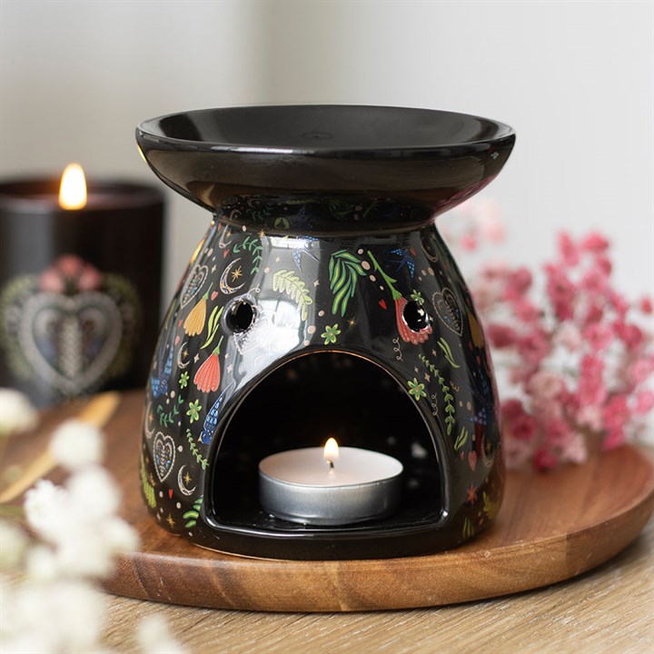 midnight bloom floral ceramic oil burner styled in home setting with dark botanical design