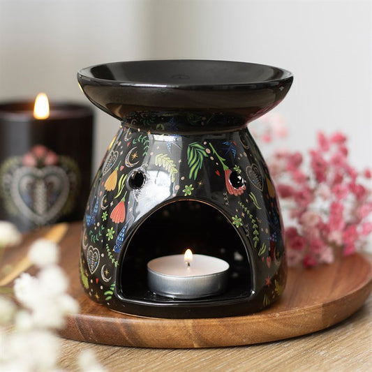 midnight bloom floral ceramic oil burner styled in home setting with dark botanical design