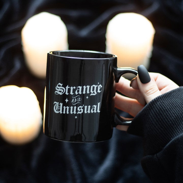 strange and unusual gothic ceramic mug styled in home setting with bold lettering