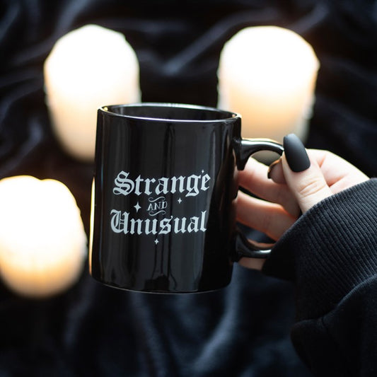 strange and unusual gothic ceramic mug styled in home setting with bold lettering