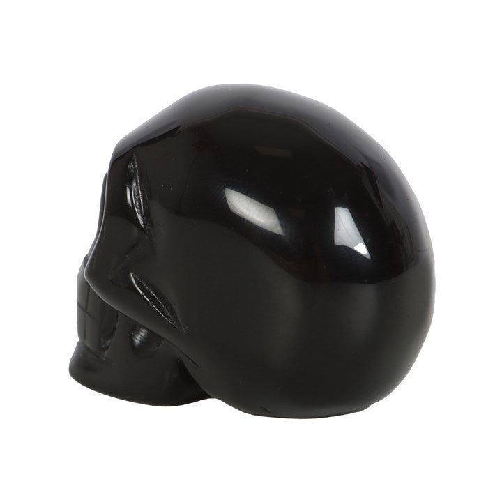 rear view of black obsidian crystal skull highlighting smooth carved finish