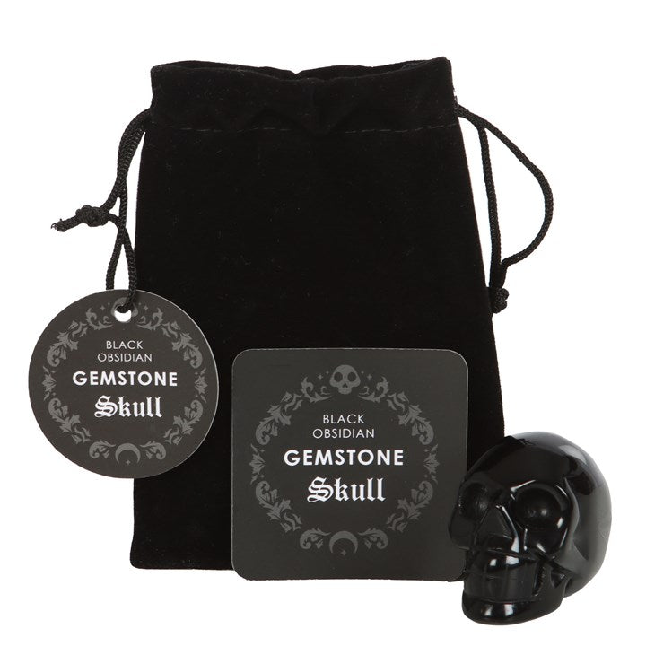 black obsidian crystal skull shown unbagged beside protective drawstring pouch