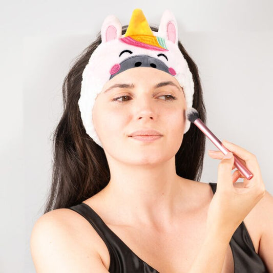 adoracorns astra the unicorn plush beauty headband worn on model holding hair back