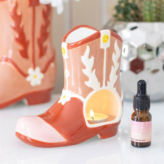 pink cowboy boot oil burner styled in home setting as playful statement home fragrance piece