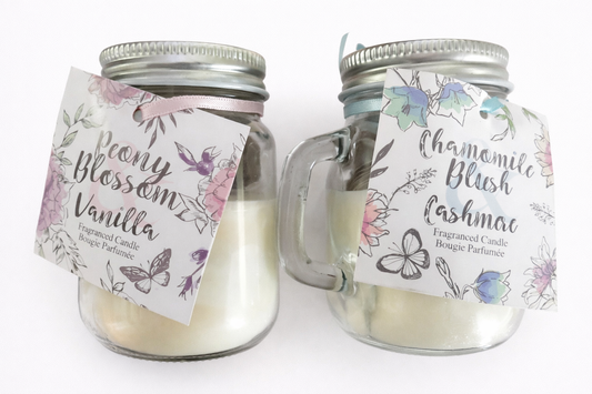 glass jar scented candle with handle displaying peony blossom and chamomile blush options