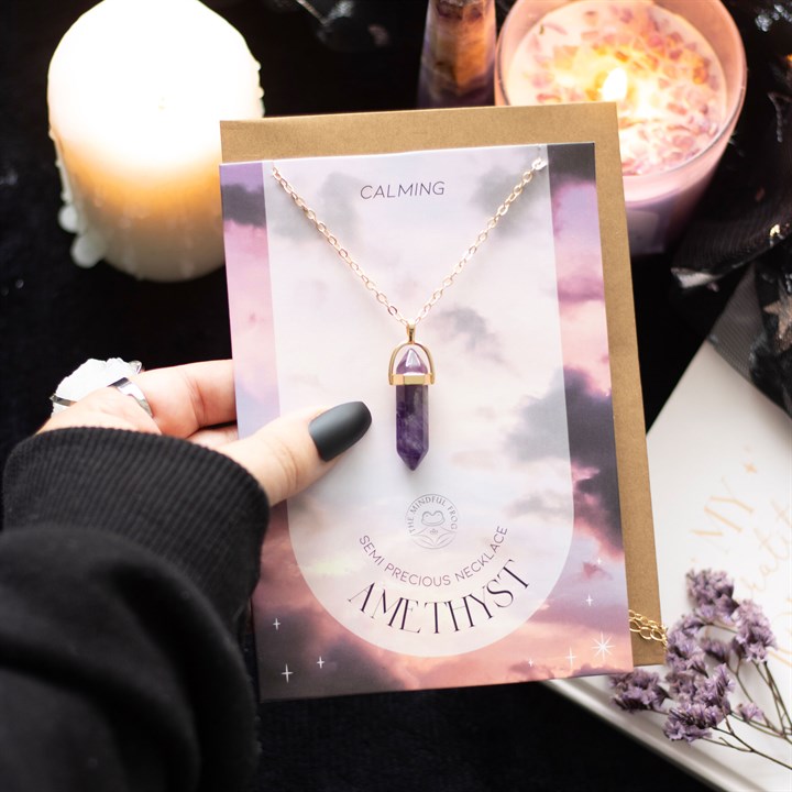 amethyst crystal pendant necklace greeting card held in hand with atmospheric styling