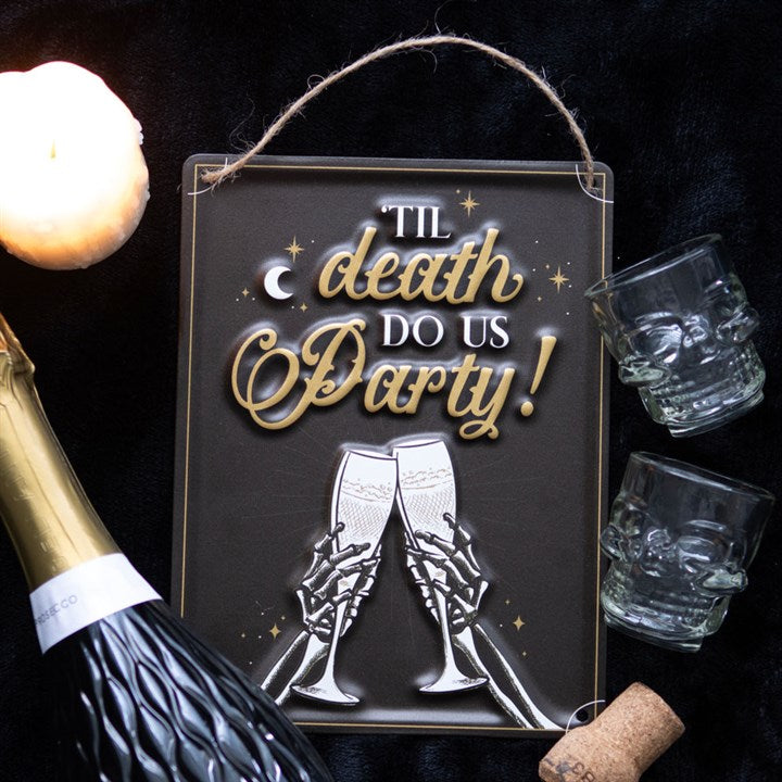 til death do us party champagne hanging metal sign styled in celebratory home setting