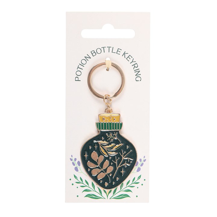 green witch potion bottle keyring displayed on presentation card against clean background