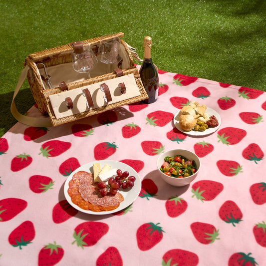 strawberry fleece throw styled in outdoor picnic setting as decorative and cosy blanket