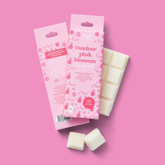 pink packaging of 'outdoor pink blossom' with white cubes on a pink background