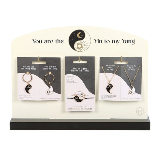 yin and yang matching jewellery pieces displayed together on stand symbolising balance and connection