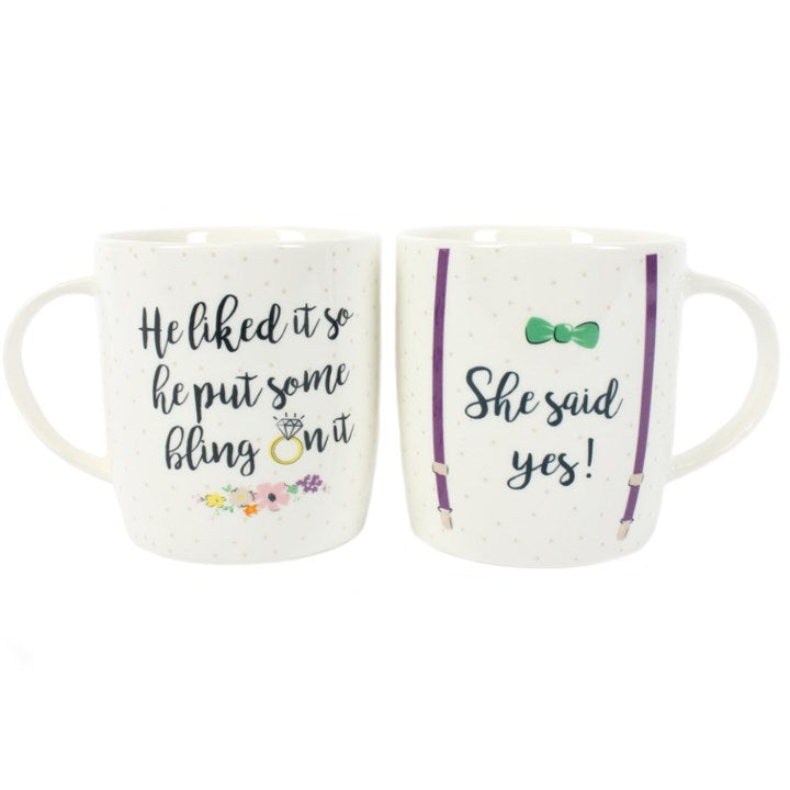 engagement mugs shown together displaying playful proposal themed wording