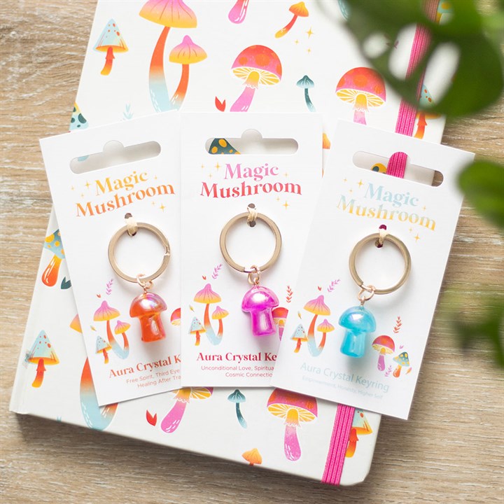 aura mushroom keyring shown with multiple symbolic variants styled in home setting