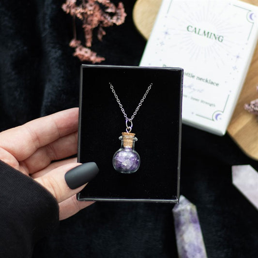 amethyst crystal potion bottle necklace held in hand showing giftable mystical jewellery