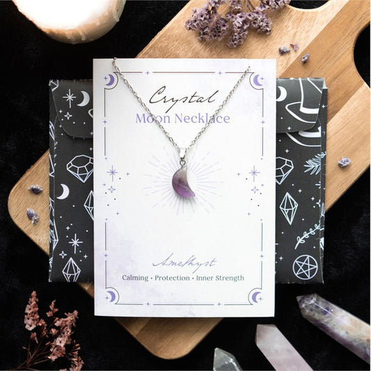 amethyst crystal moon necklace displayed on greeting card with celestial design