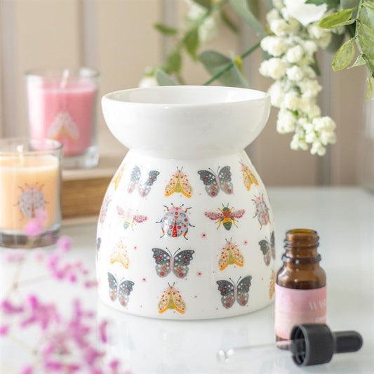 floral bug ceramic oil burner styled in colourful home setting