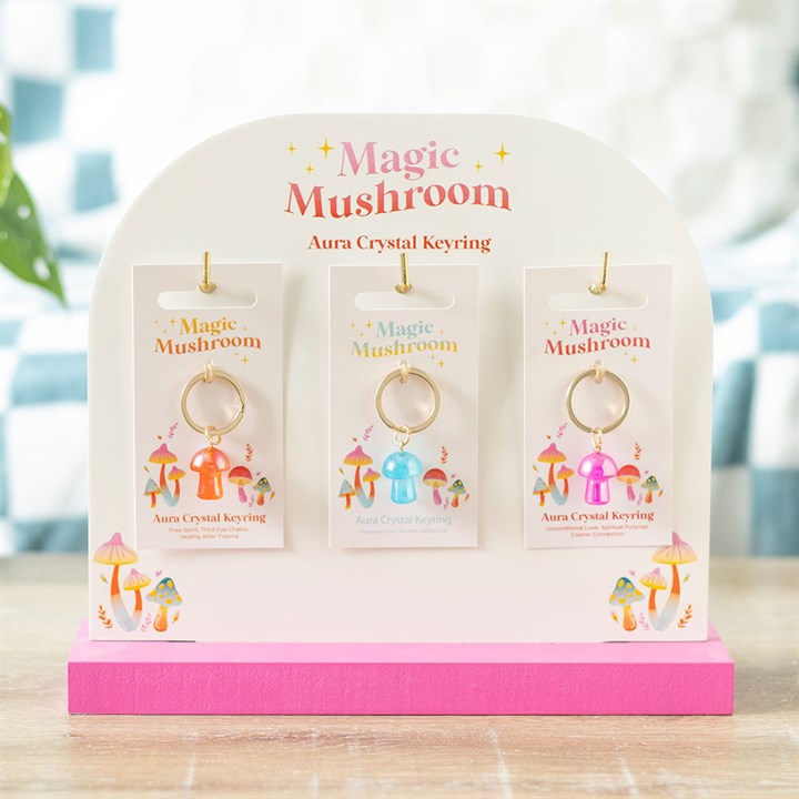 mushroom charm keyring variants displayed together on stand for giftable presentation