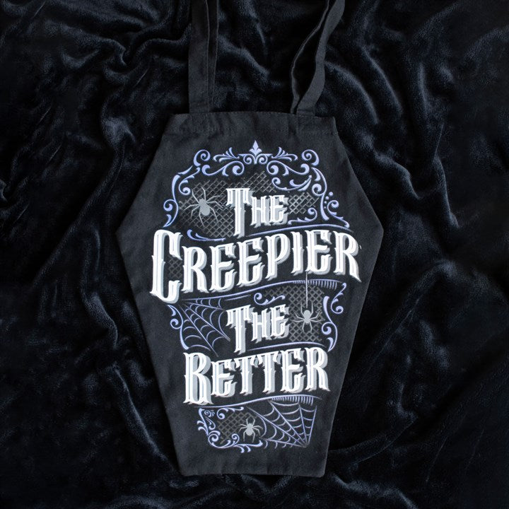 coffin shaped bag with the creepier the better text laid on black fabric