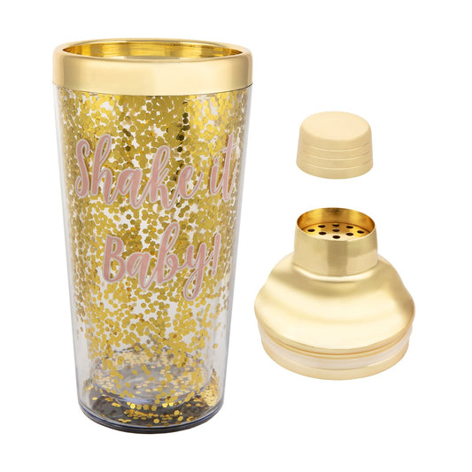 clear glass cocktail shaker with gold-toned detailing and confetti accents, lid off to the side